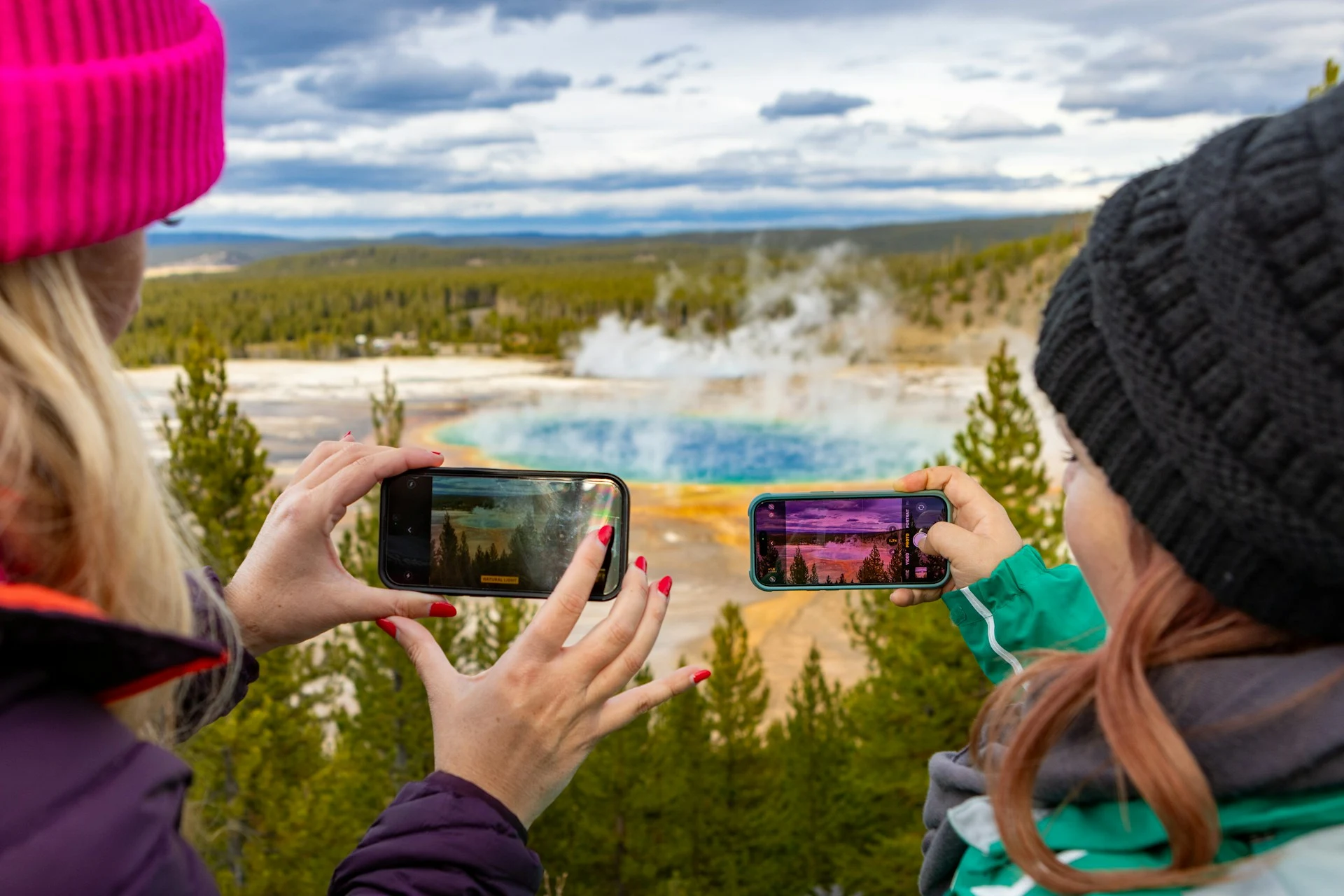 Visitors photographing Grand Prismatic Spring in Yellowstone