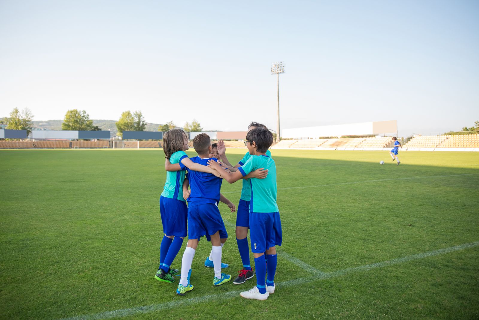 Young soccer teammates congratulating each other on the field